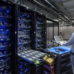EU hosting server technician works on a bank of servers.